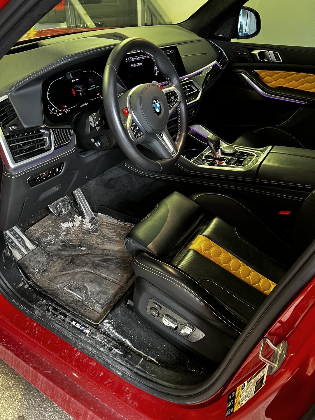 Before detail — BMW X5 interior with winter salt crust on floor mats and sill